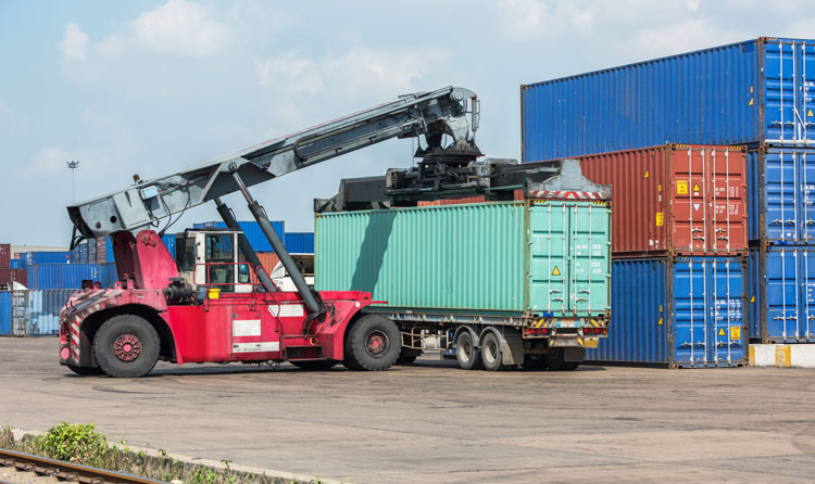 crane loading container on truck