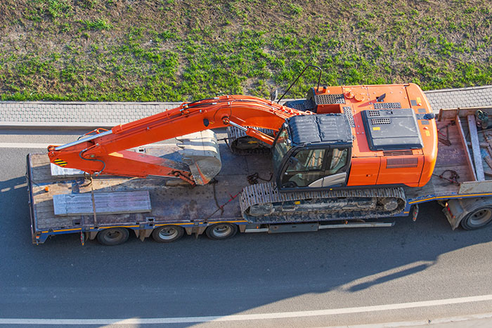 hauling construction equipment-on-trailer