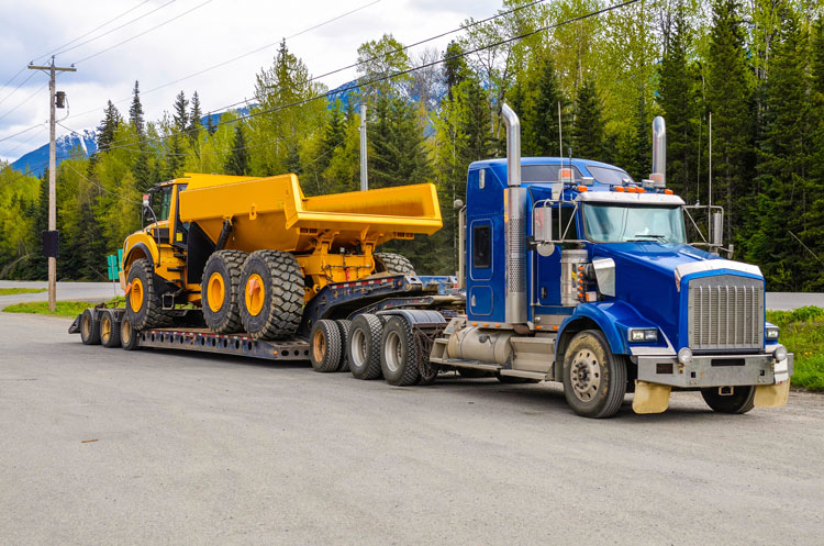 semi truck hauling dump truck