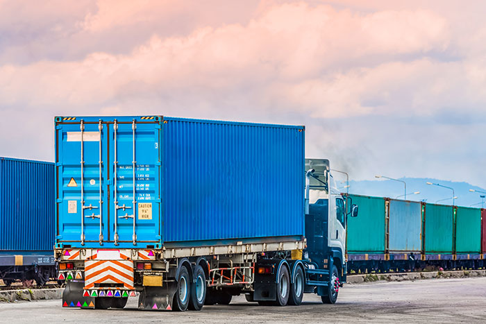 truck picking up container from railyard