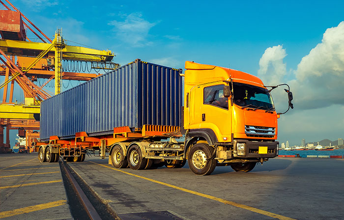 truck picking up container from shipyard